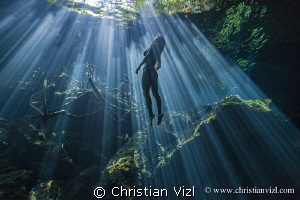  Morning sun rays Cenote Cristalino Quintana Roo Mxico. model was freediving amazed awe beauty this spectacular natural wonders. México. México wonders  